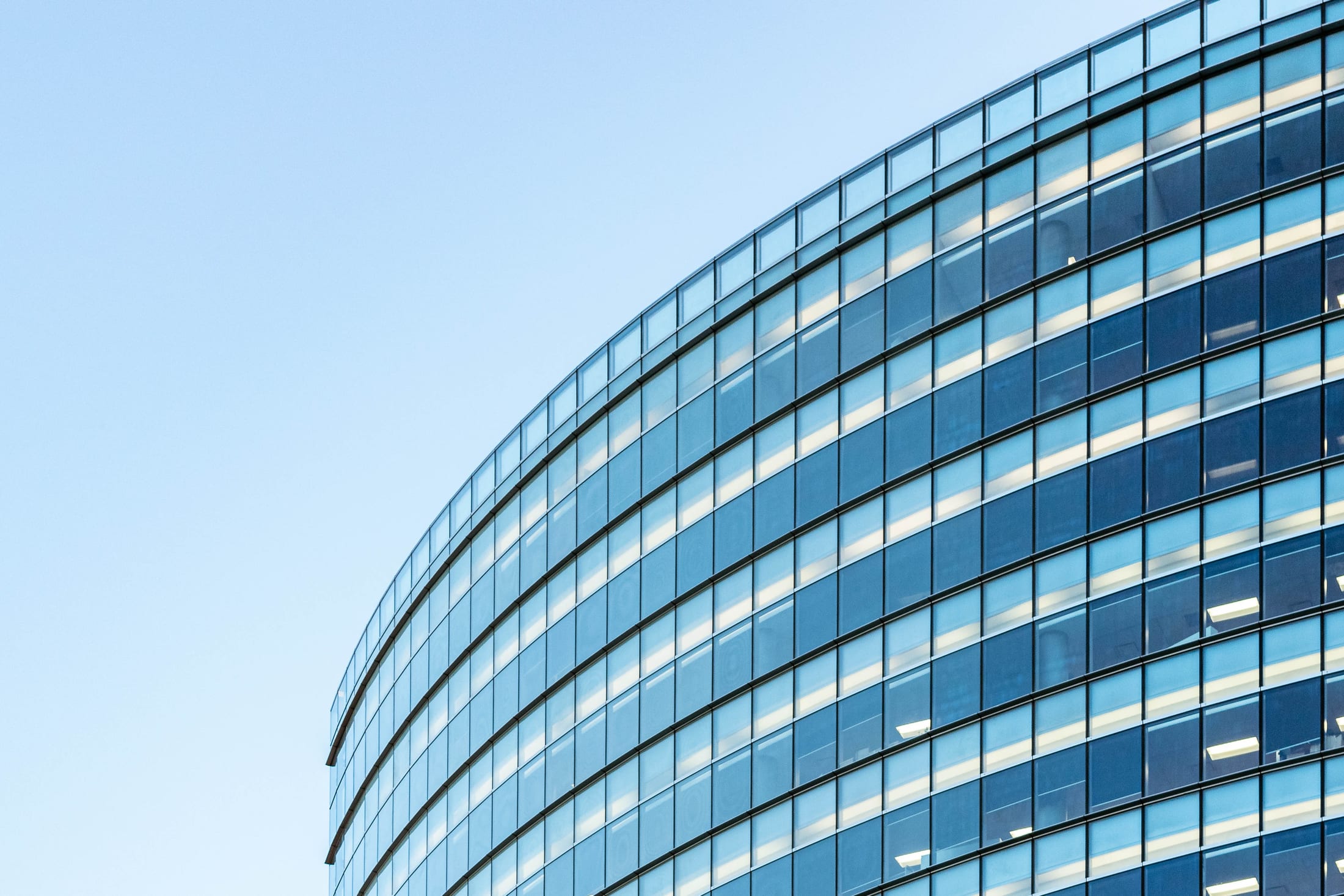 Sculptural glass architecture reflecting the sky